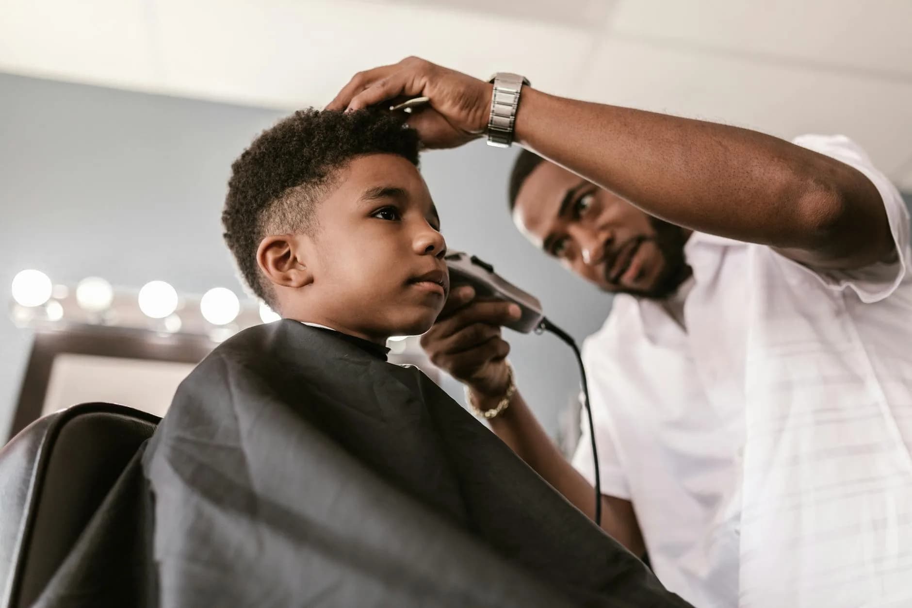 Barber apprentice cutting hair
