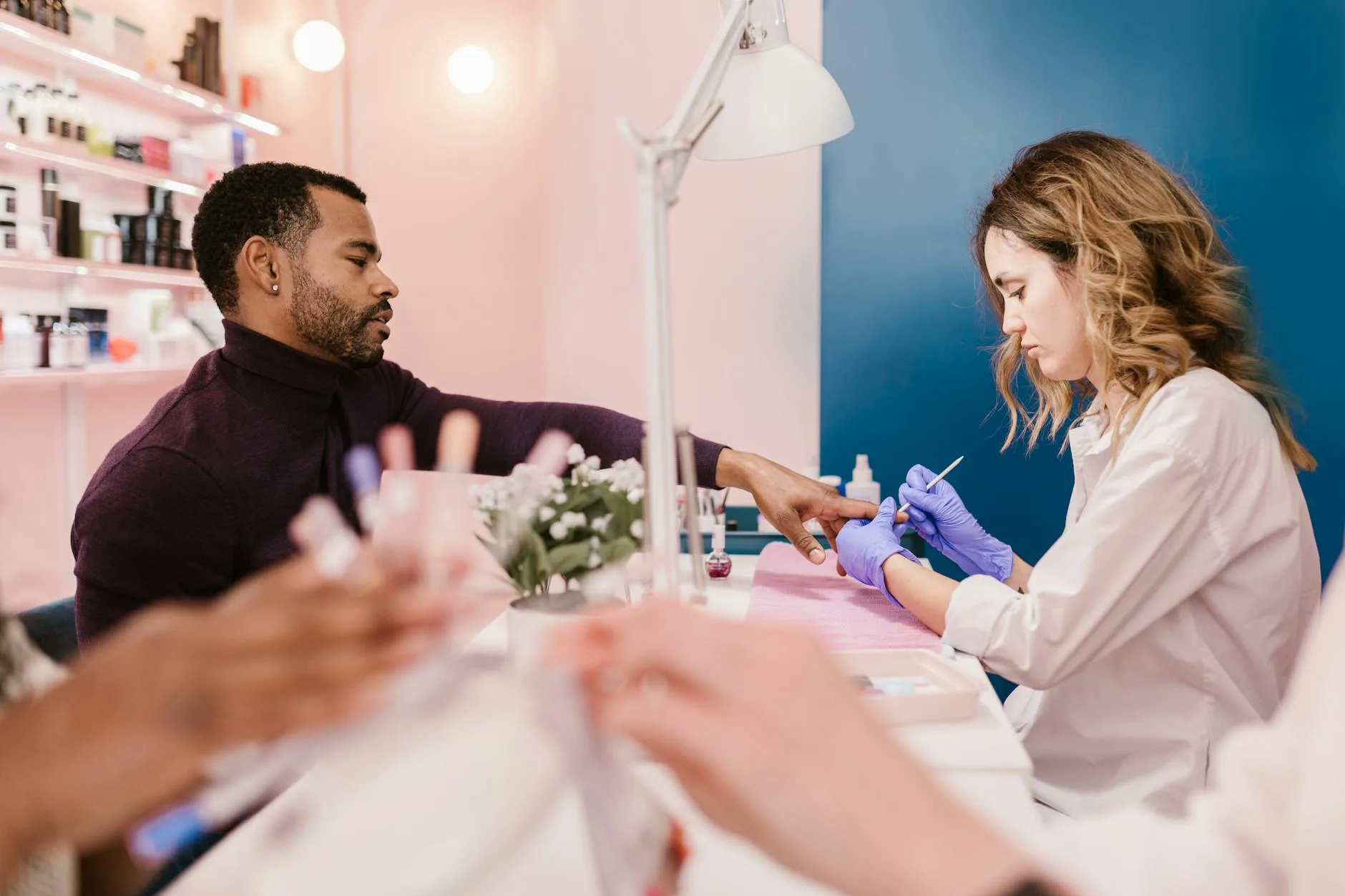 Nail technician apprentice performing a manicure