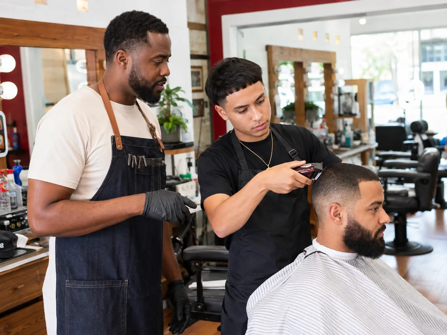 Barber apprentice building hands-on skills with professional supervision