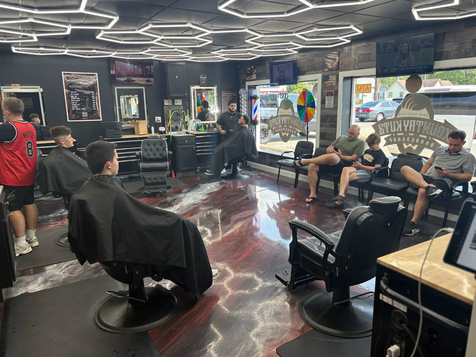 Barbers and clients inside Kountry Kutz Barbershop