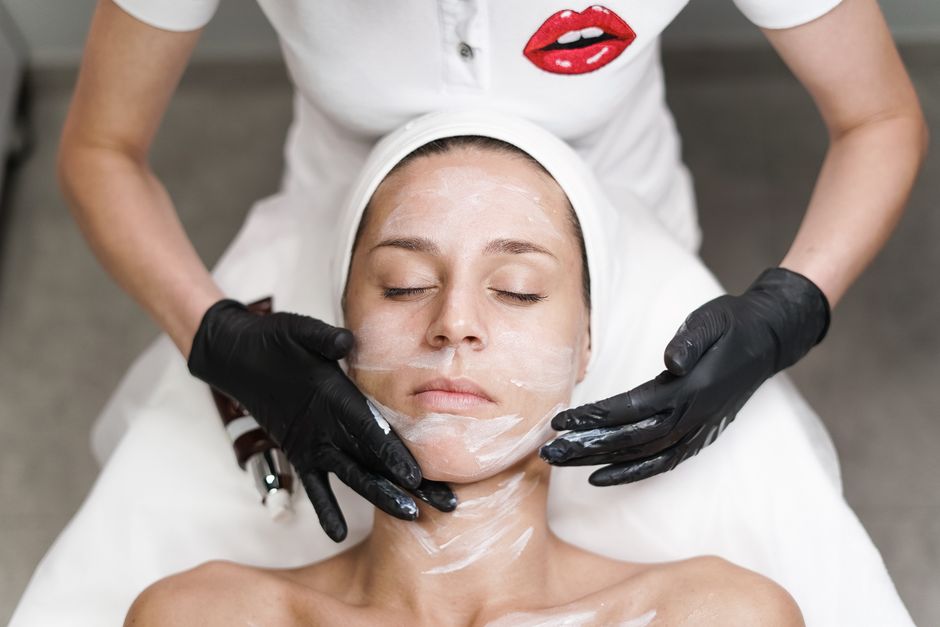 Esthetics apprentice completing supervised skincare training